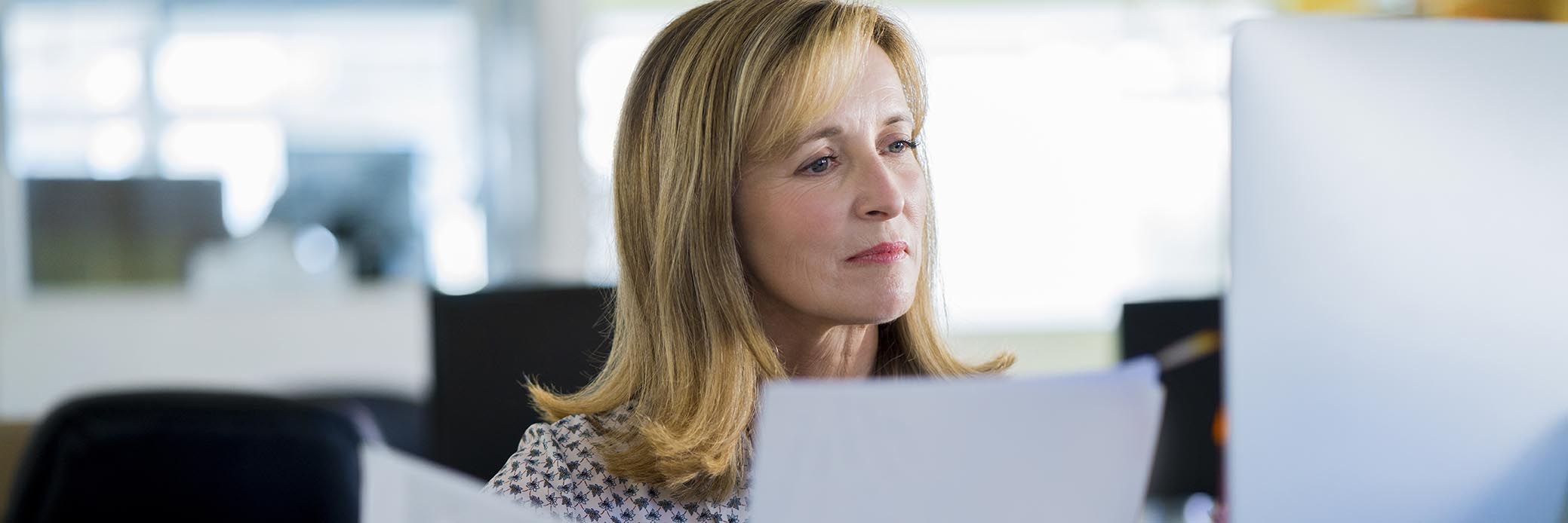 woman in office looking through papers